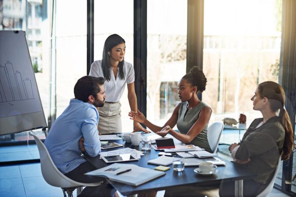 People, business meeting and audit in boardroom for budget plan and financial logistics. Corporate group, teamwork and company review with conversation and discussion about available resources.